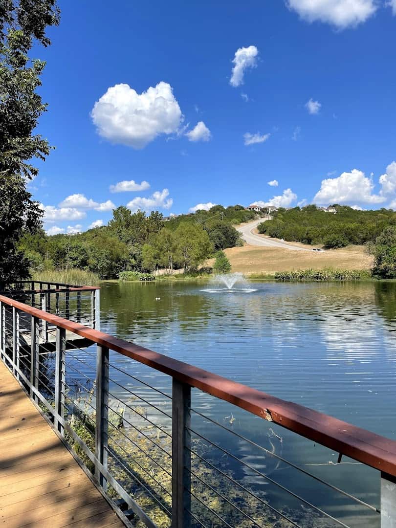 Wooden boardwalk crossing the lake at River Place Nature Trail in Austin, Texas