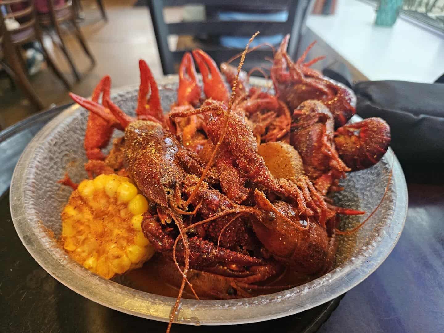 Bowl of seasoned boiled crawfish with corn at Fish Shack in Plano, Texas