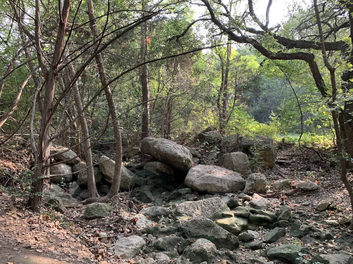 Boulders and rocky forest floor at the base of the canyon on River Place Nature Trail, Austin, Texas