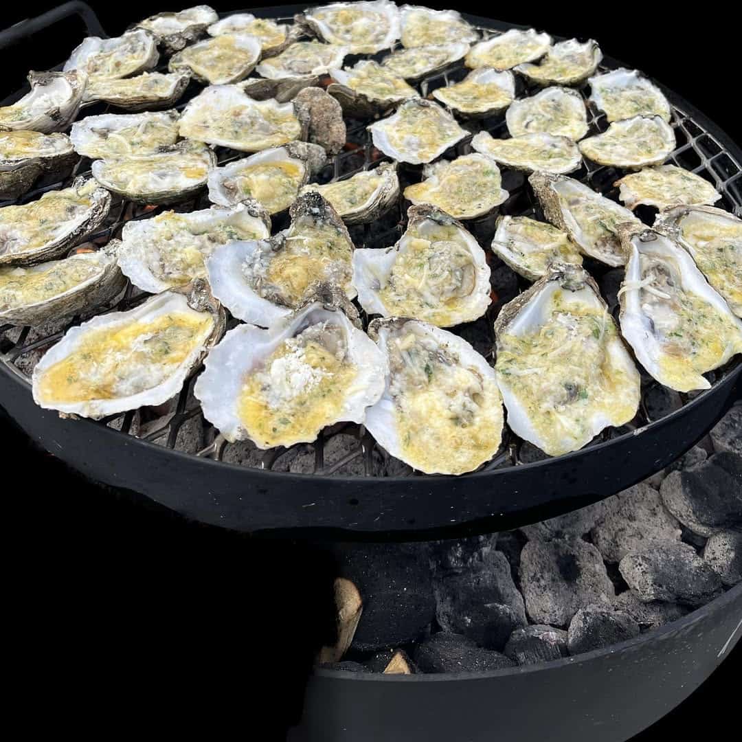 Wood-roasted oysters on the grill at Bowens Island Restaurant near Charleston, South Carolina