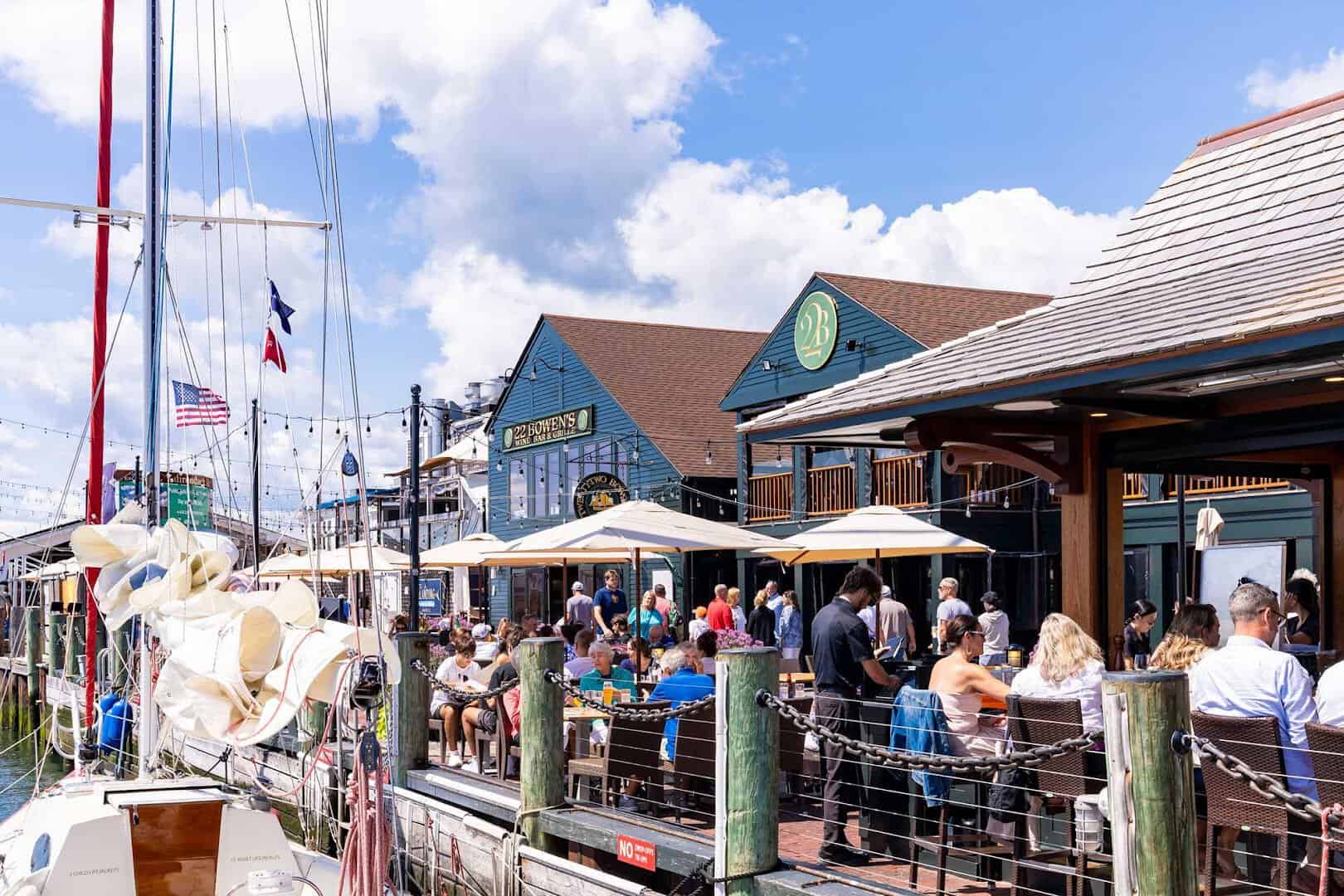 Dockside dining and sailboats at Bowen's Wharf in Newport, Rhode Island