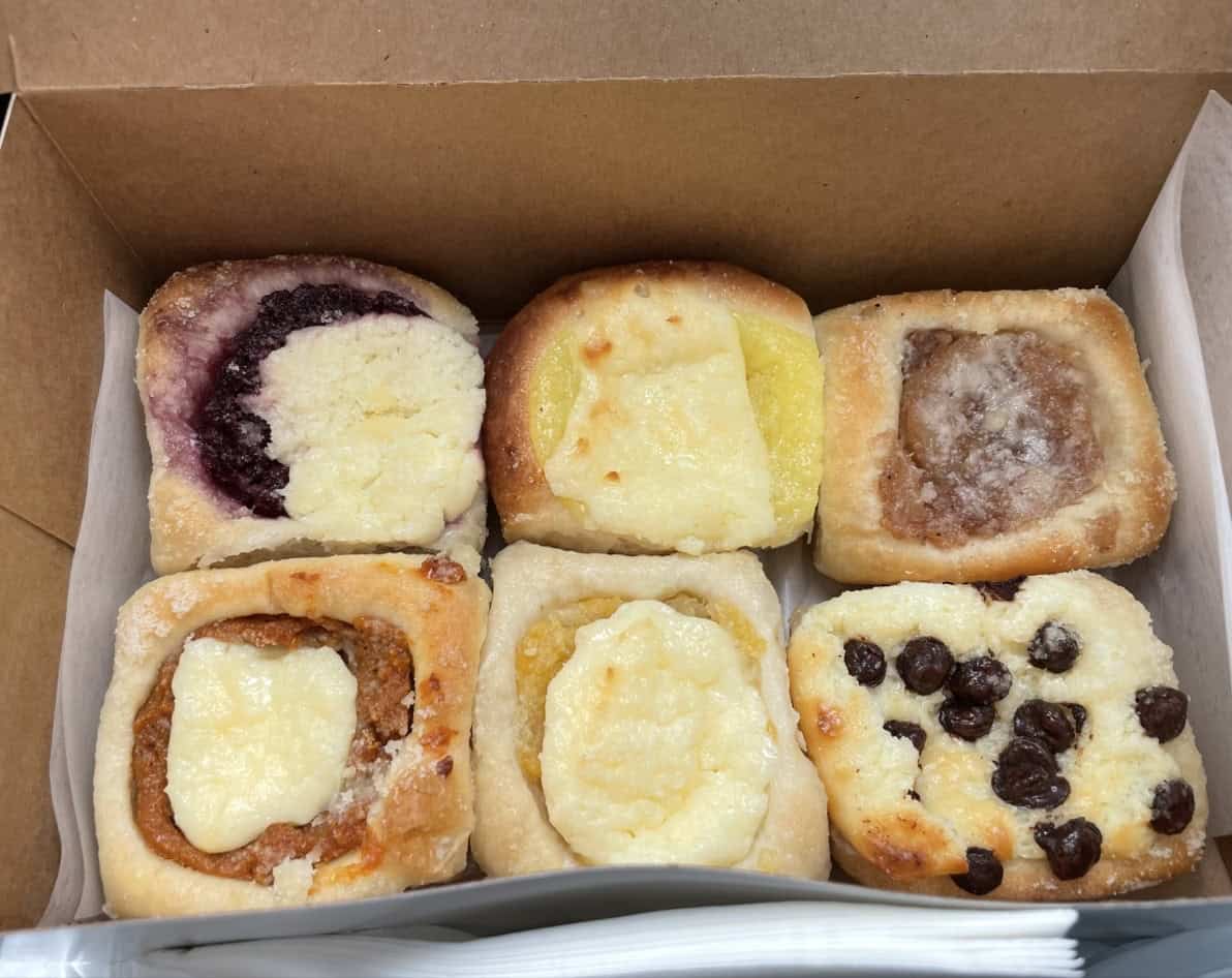 A pink box of assorted fruit and cream cheese kolaches from Czech Stop in West, Texas