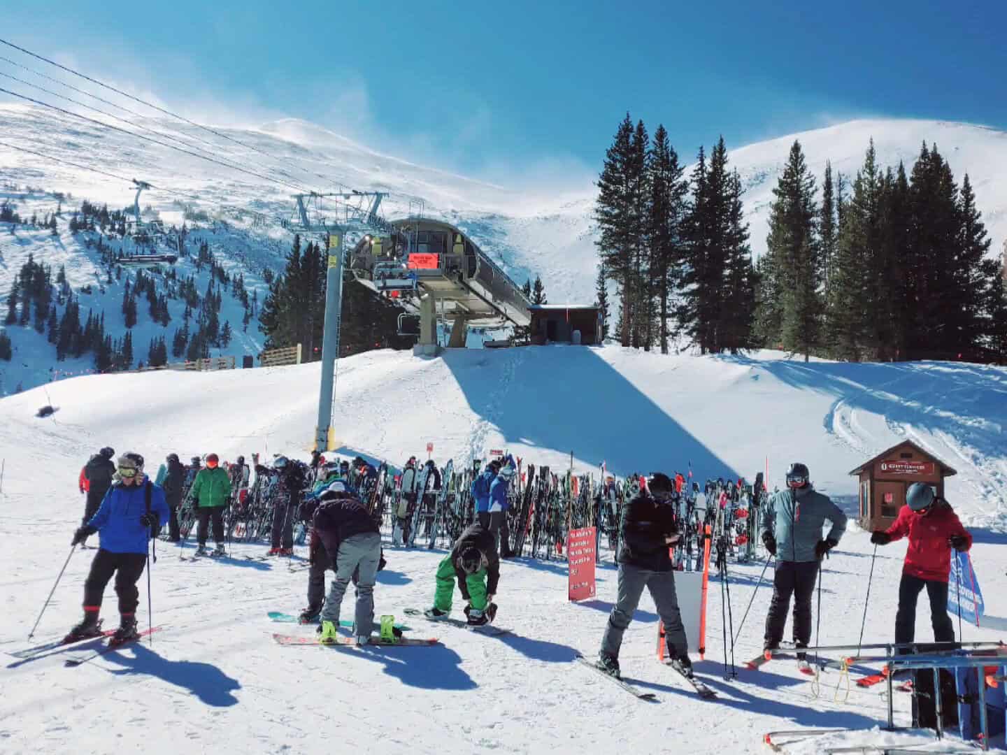Skiers on snow-covered ski slopes above Breckenridge, Colorado