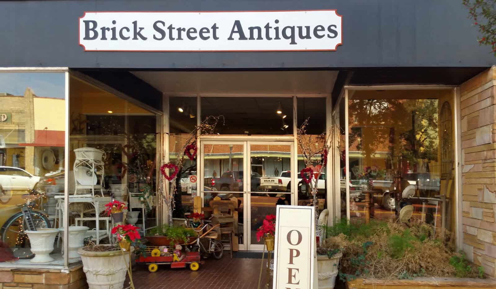 Brick Street Antiques storefront with wares on the sidewalk in Nacogdoches, Texas