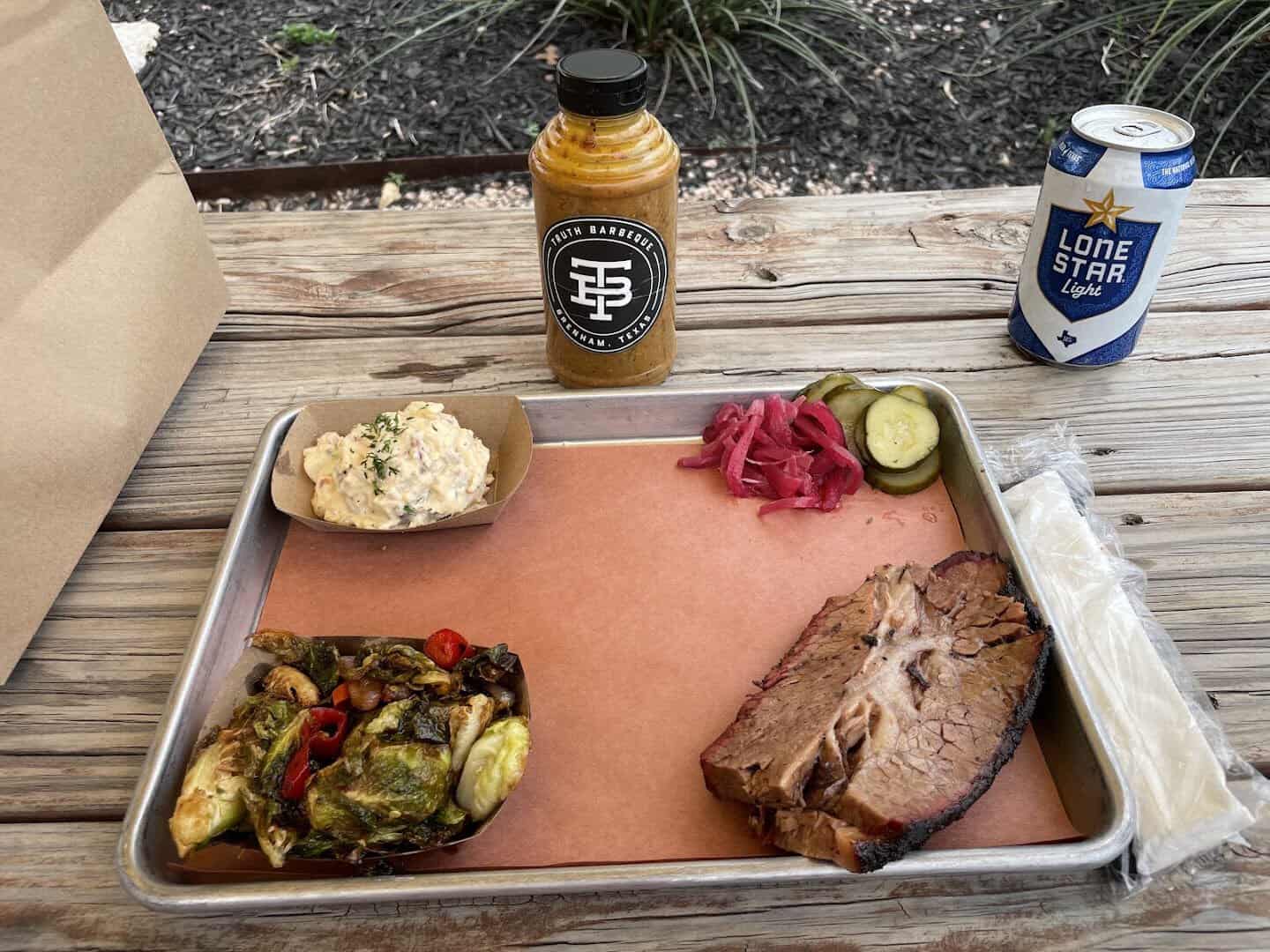 Sliced brisket plate with sides at Truth Barbeque in Brenham, Texas