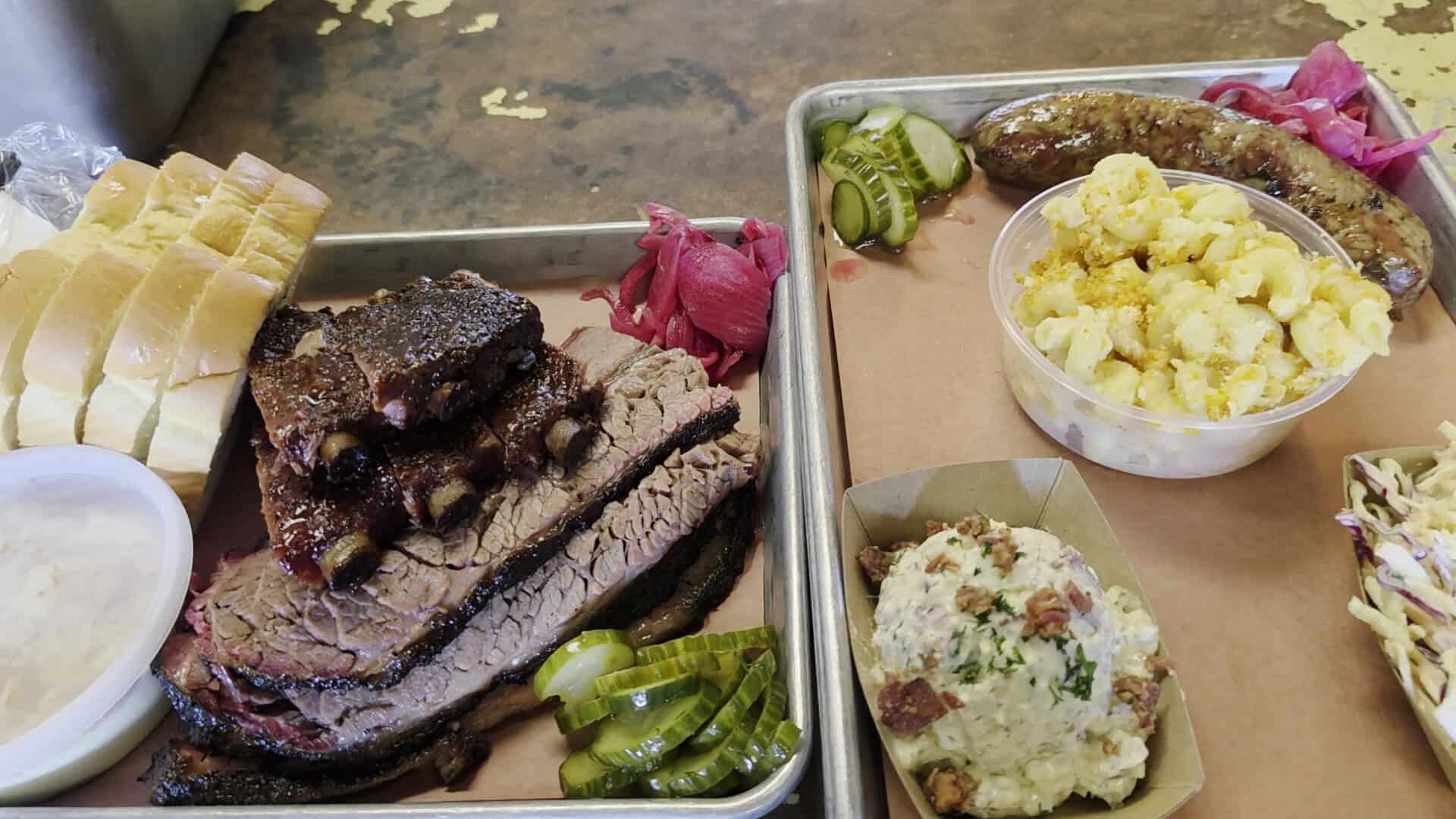 Sliced brisket and sausage spread on butcher paper at Truth Barbeque in Brenham, Texas