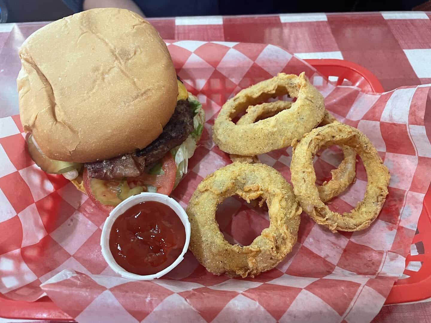 Cheeseburger with a stack of cornmeal-battered onion rings at Texan Cafe and Pie Shop in Hutto, Texas