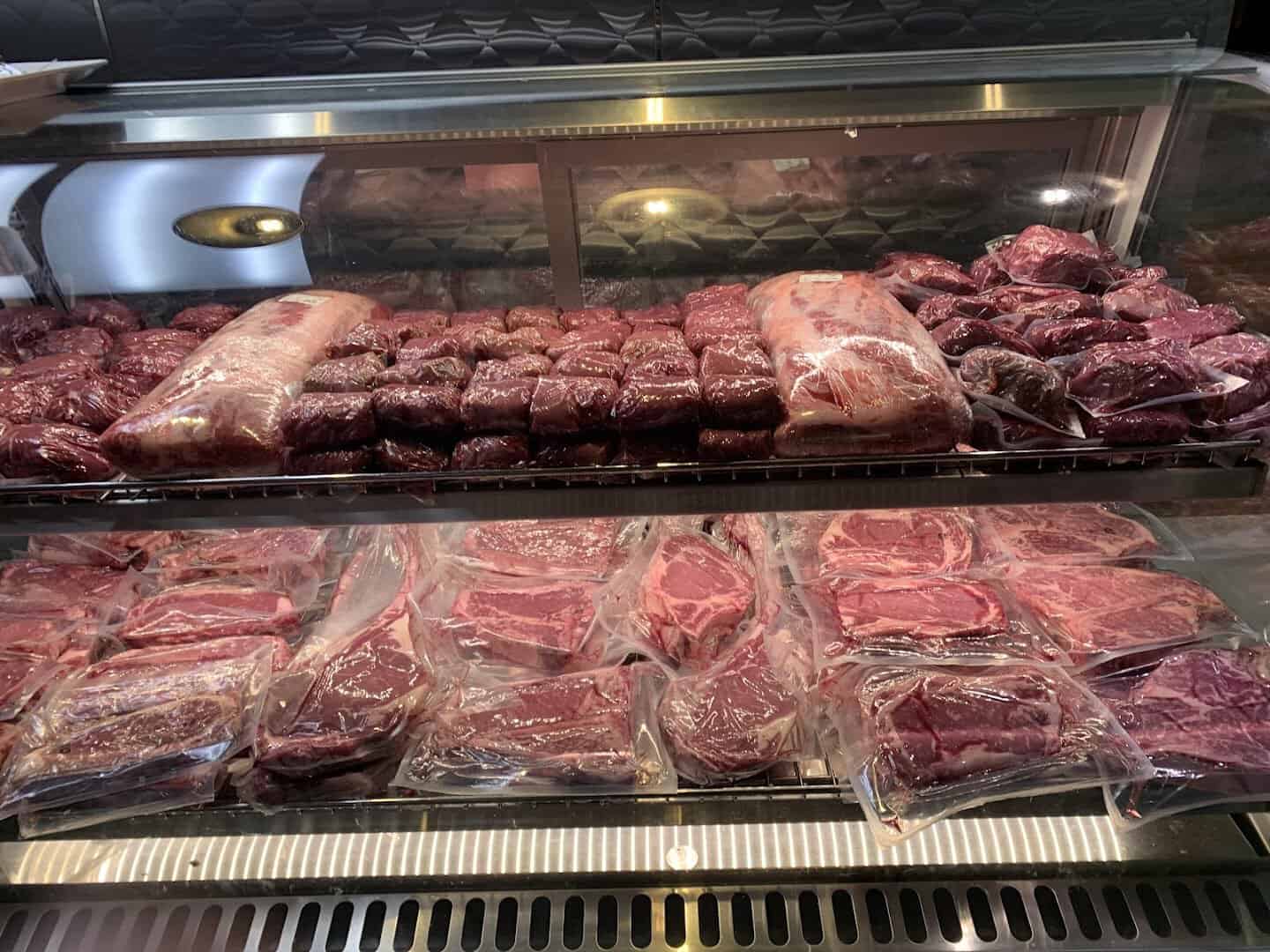 Fresh Certified Angus Beef steaks in the butcher case at Taste of Texas in Houston