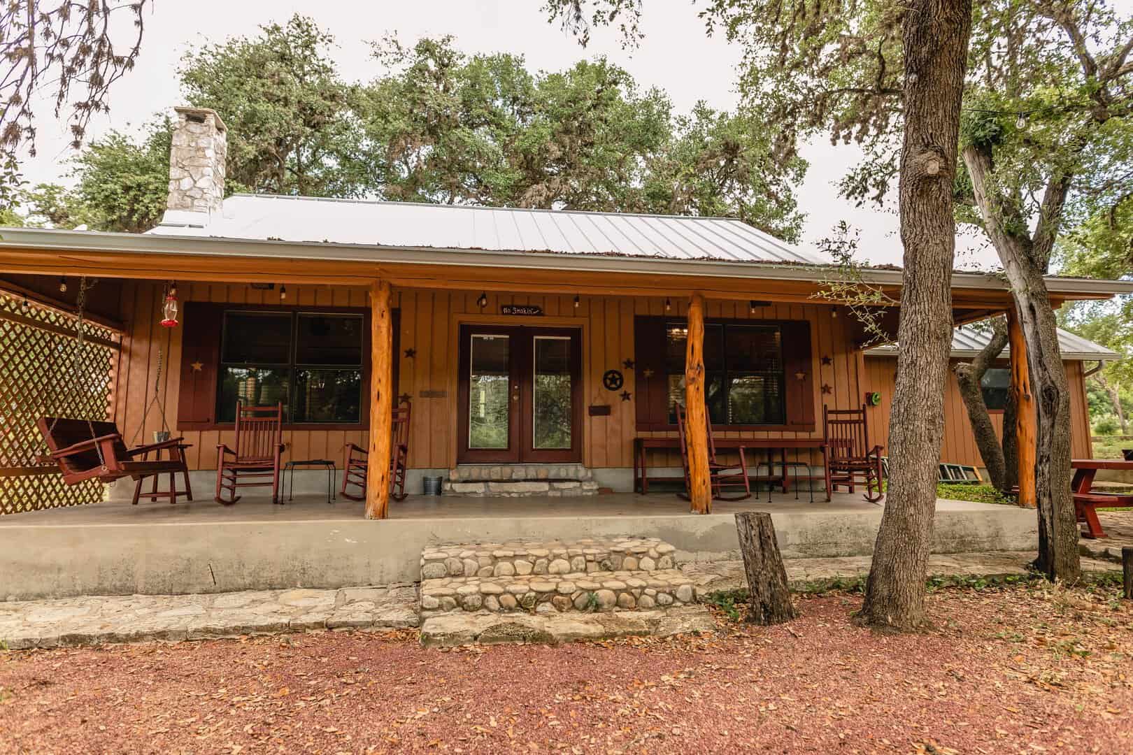 Rocking chairs on a river cabin porch in Concan, Texas