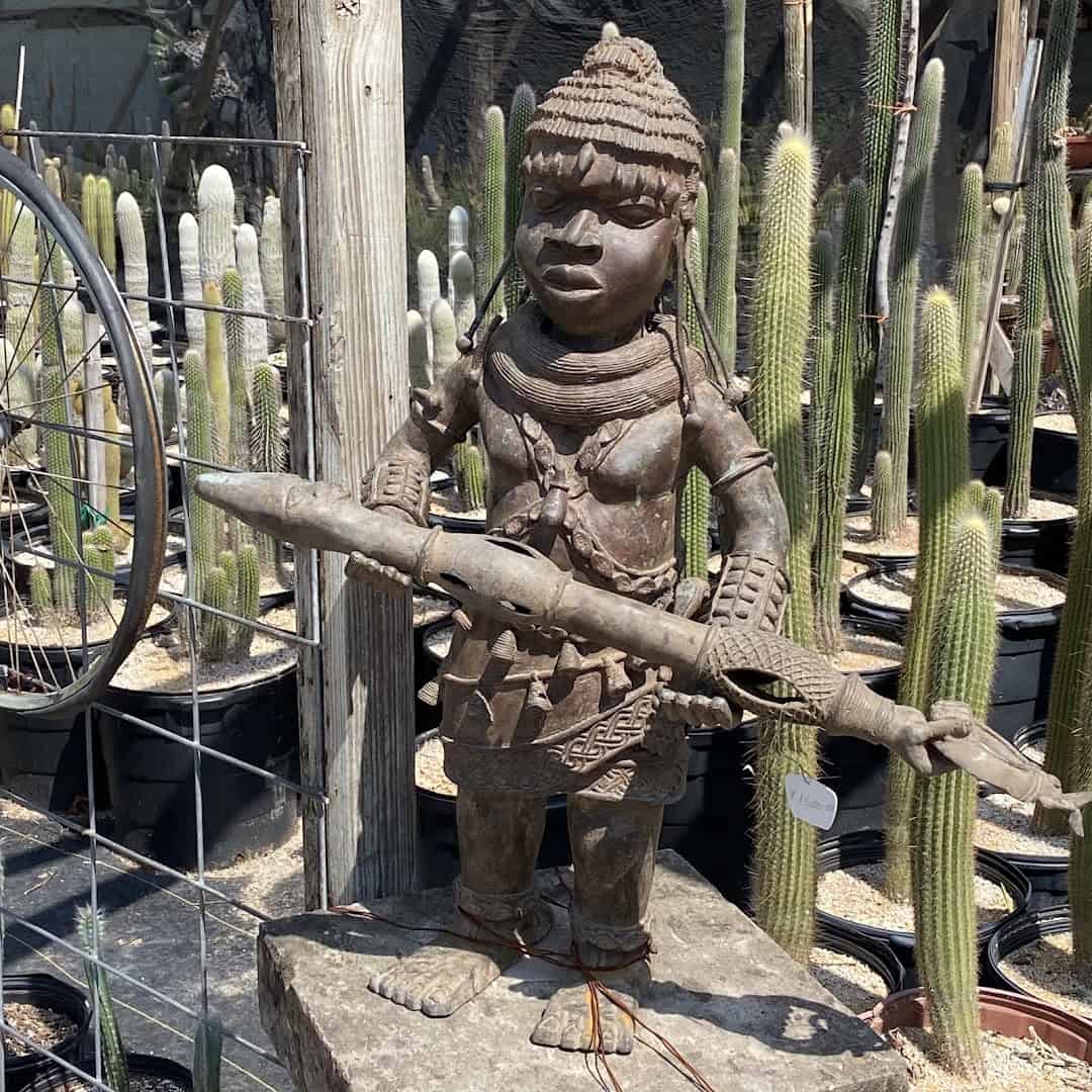 Bronze warrior sculpture among the cacti at The Cactus King in Texas
