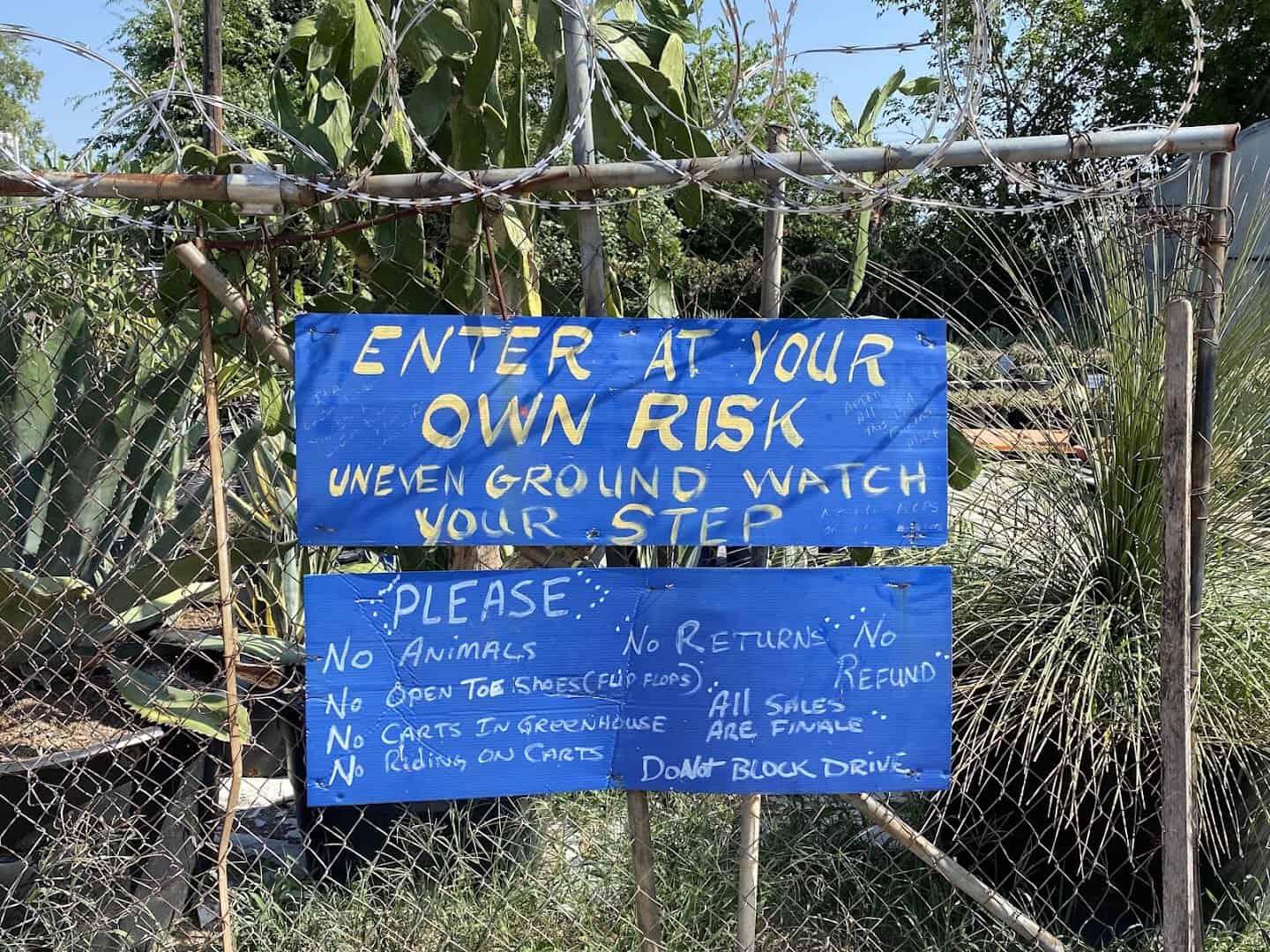Hand painted Enter At Your Own Risk sign at The Cactus King in Texas