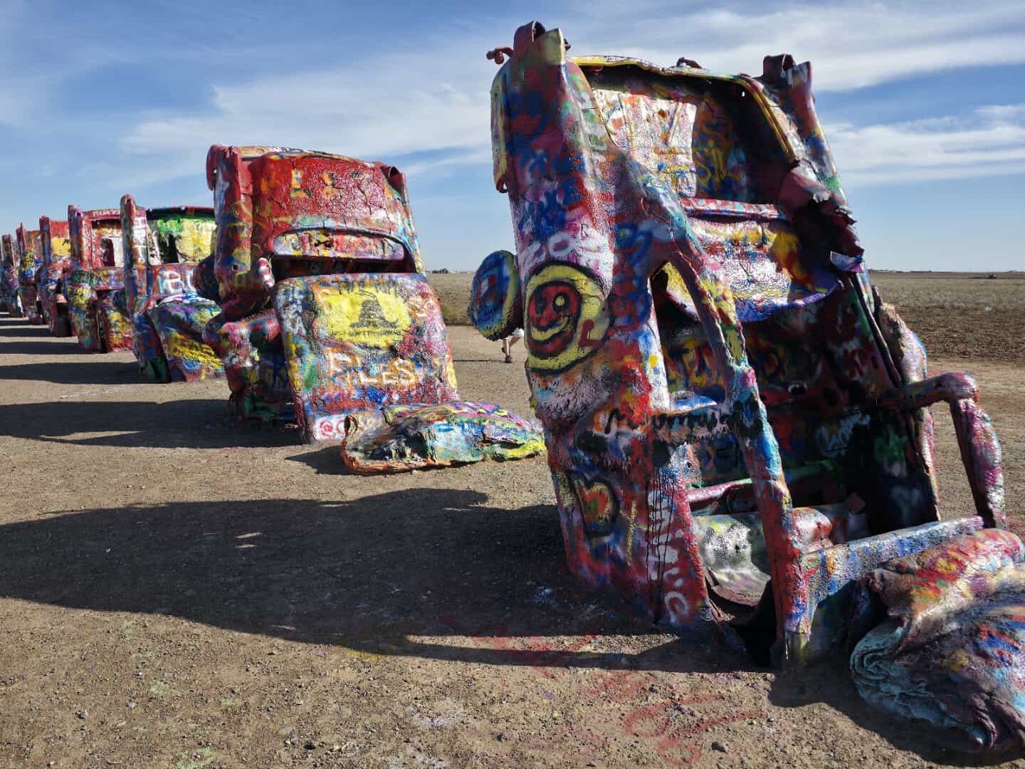 Spray-painted Cadillacs half buried nose-down at Cadillac Ranch near Amarillo, Texas