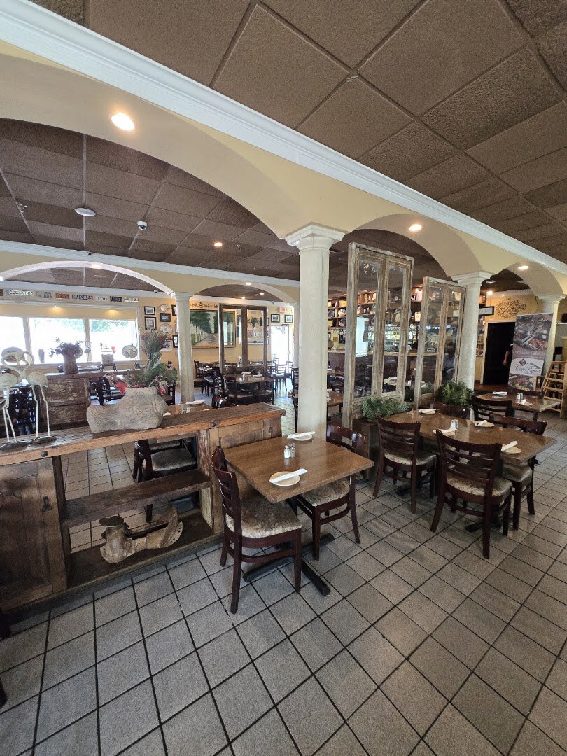 The columned dining room inside Cafe Piquet in Bellaire, Texas