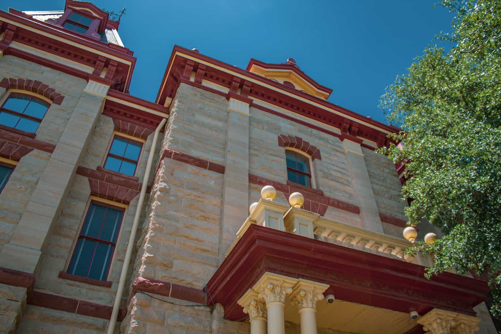 Limestone and red sandstone stonework of the Caldwell County Courthouse in Lockhart, Texas