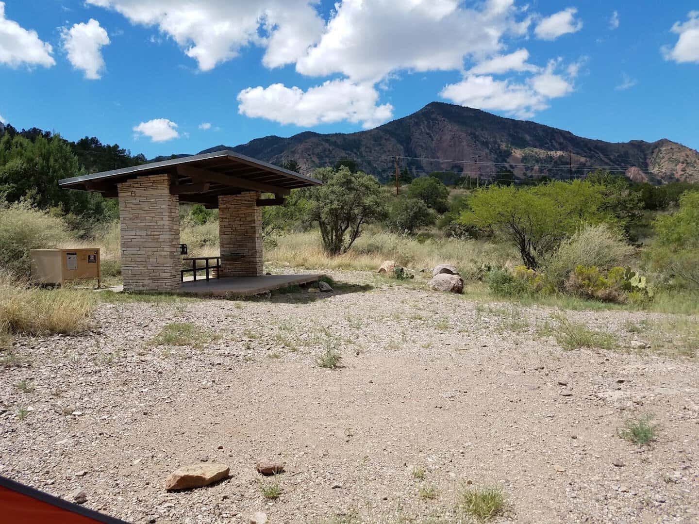 Picnic shelter and steel food storage locker at a Chisos Basin campsite