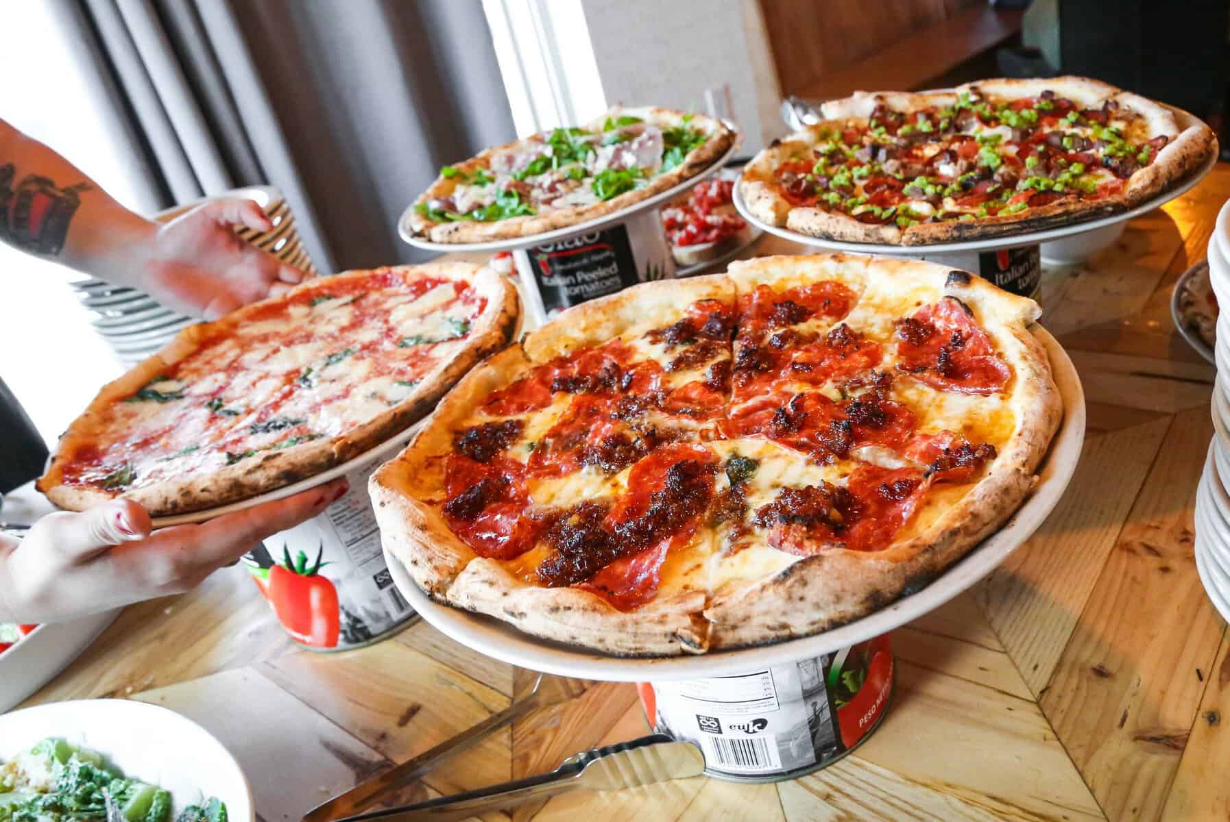 Neapolitan pizzas topped with arugula at Cane Rosso in Dallas