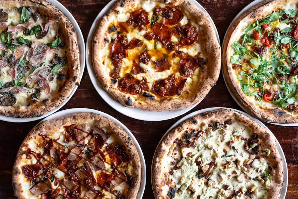 A spread of wood-fired pizzas at Cane Rosso in Dallas