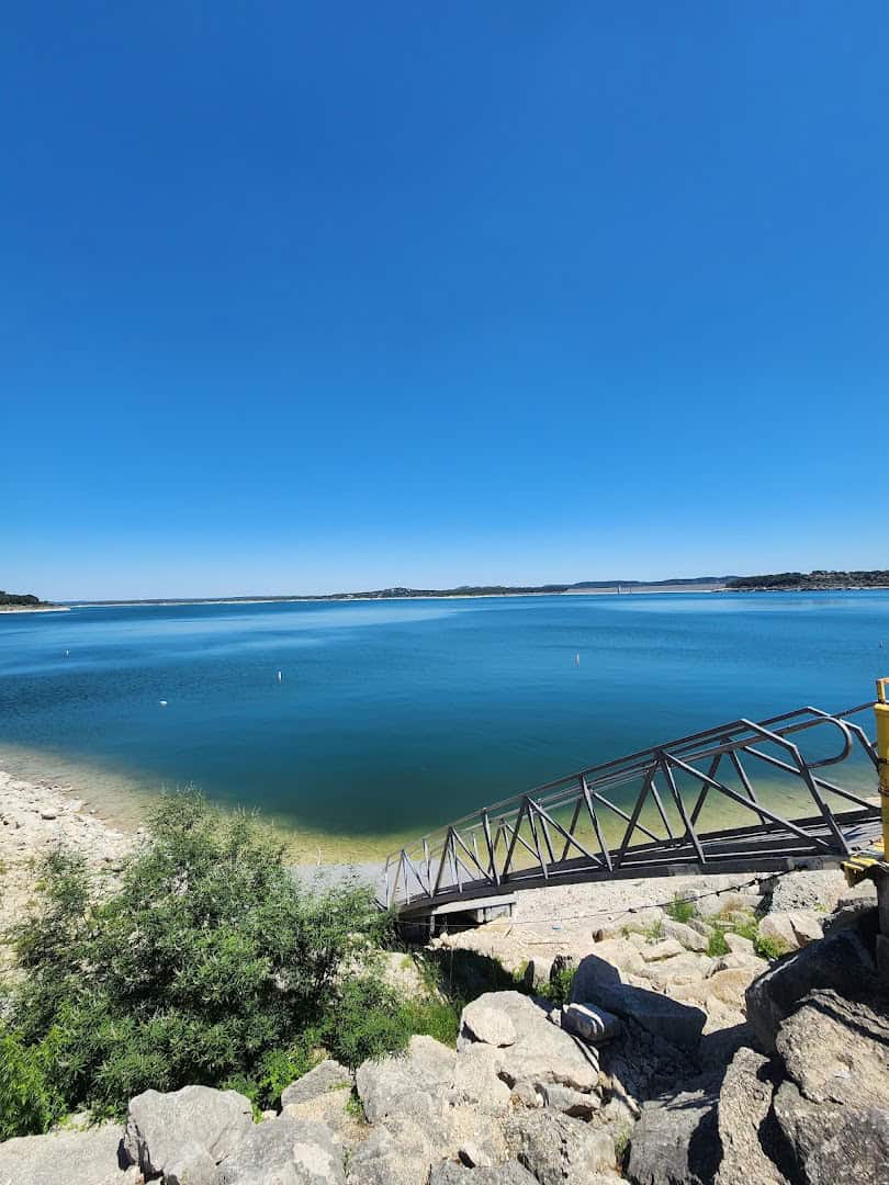 Deep blue water along the rocky shore at Canyon Lake, Texas