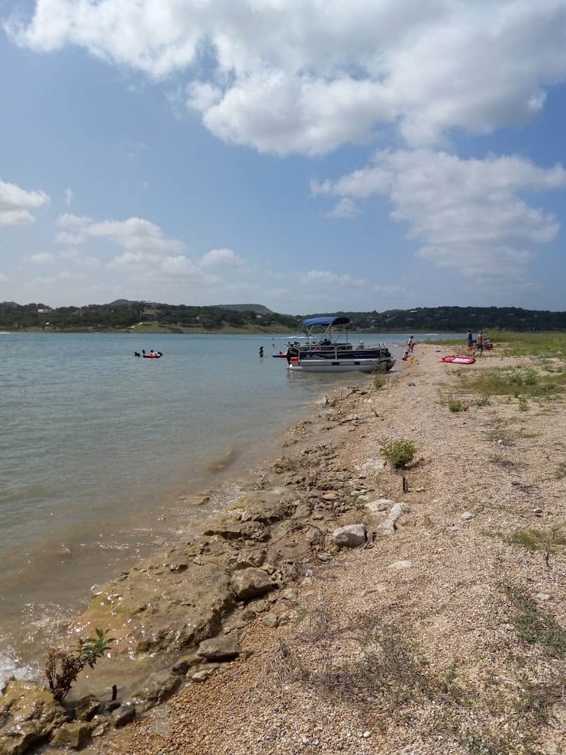Rocky shoreline and boats along a cove at Canyon Lake, Texas