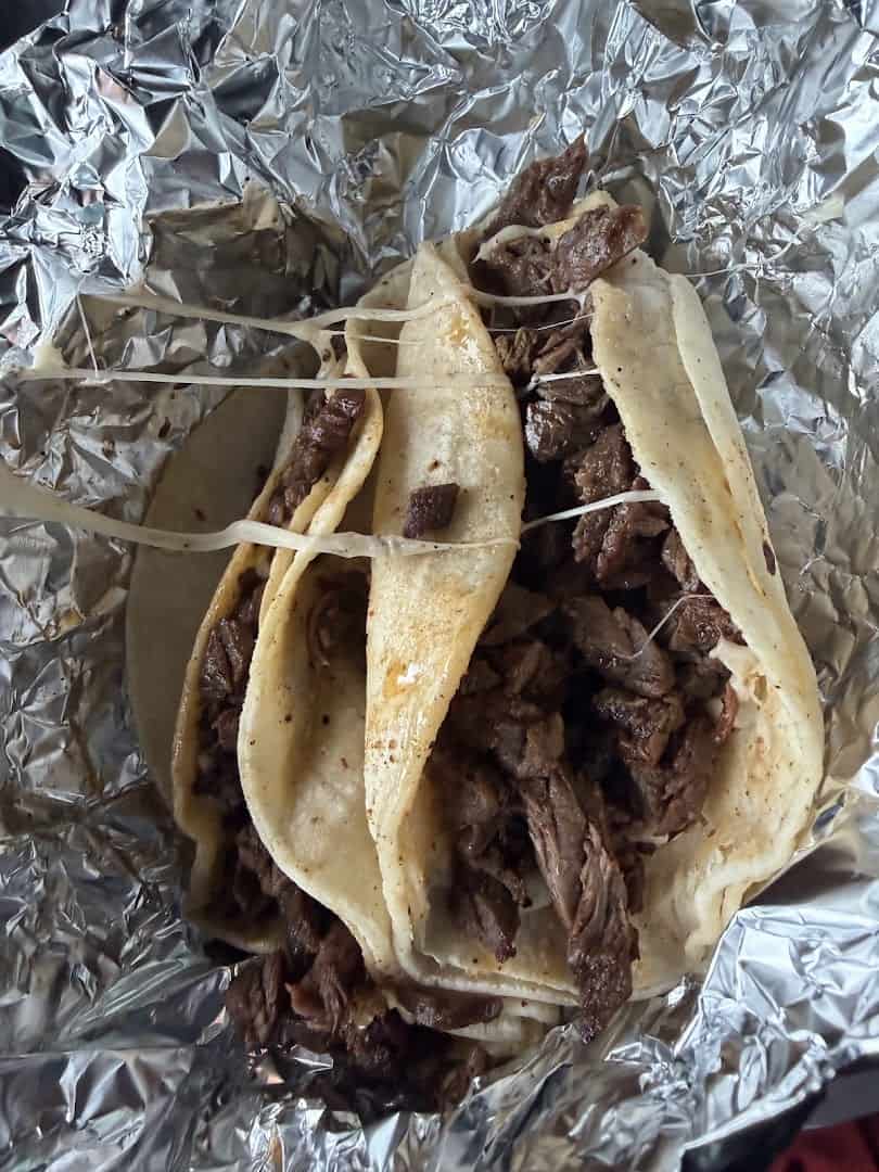 Carne asada tacos wrapped in foil at El Taconazo in Houston