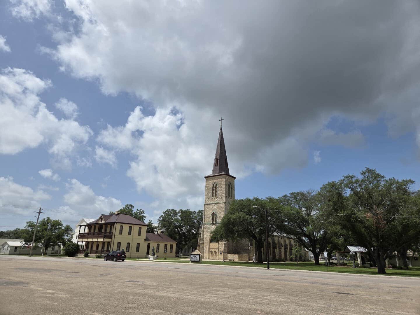 St. Louis Catholic Church spire rising over historic buildings in Castroville, Texas