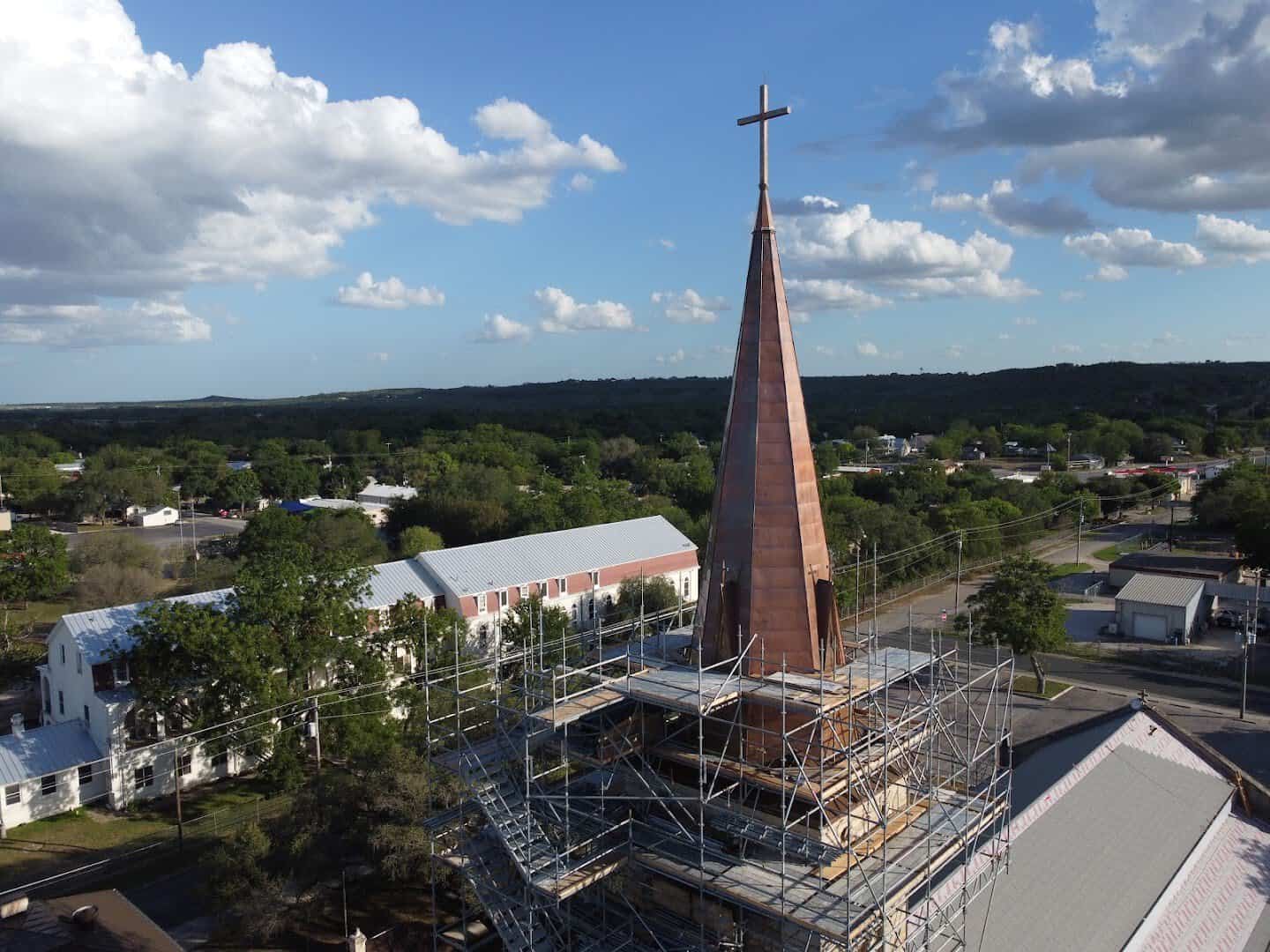 Aerial view of Castroville rooftops and the St. Louis Catholic Church spire in Texas
