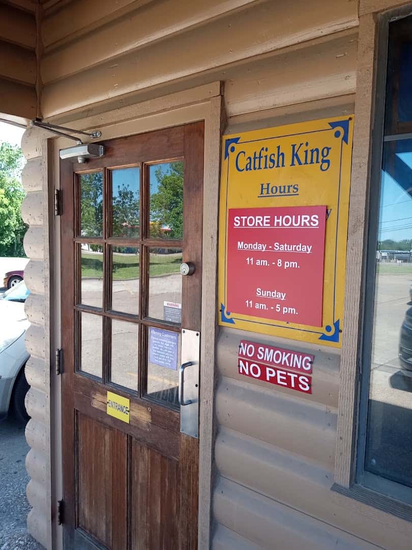Entrance and hours sign at Catfish King in Waco, Texas
