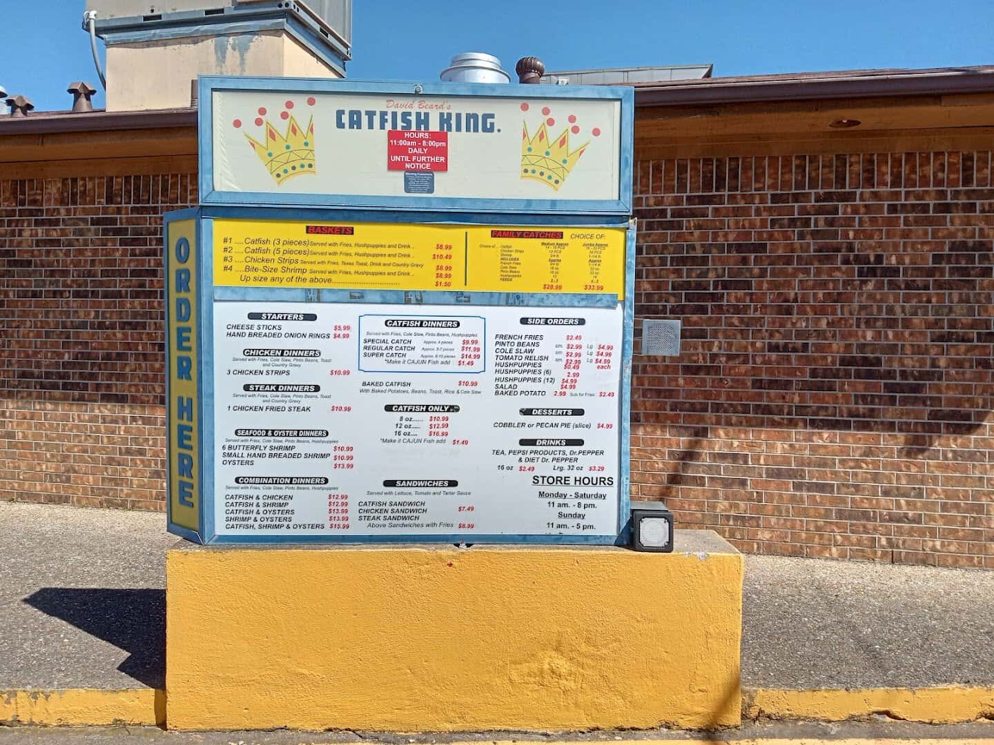 Menu board with catfish dinners and prices at Catfish King in Waco, Texas