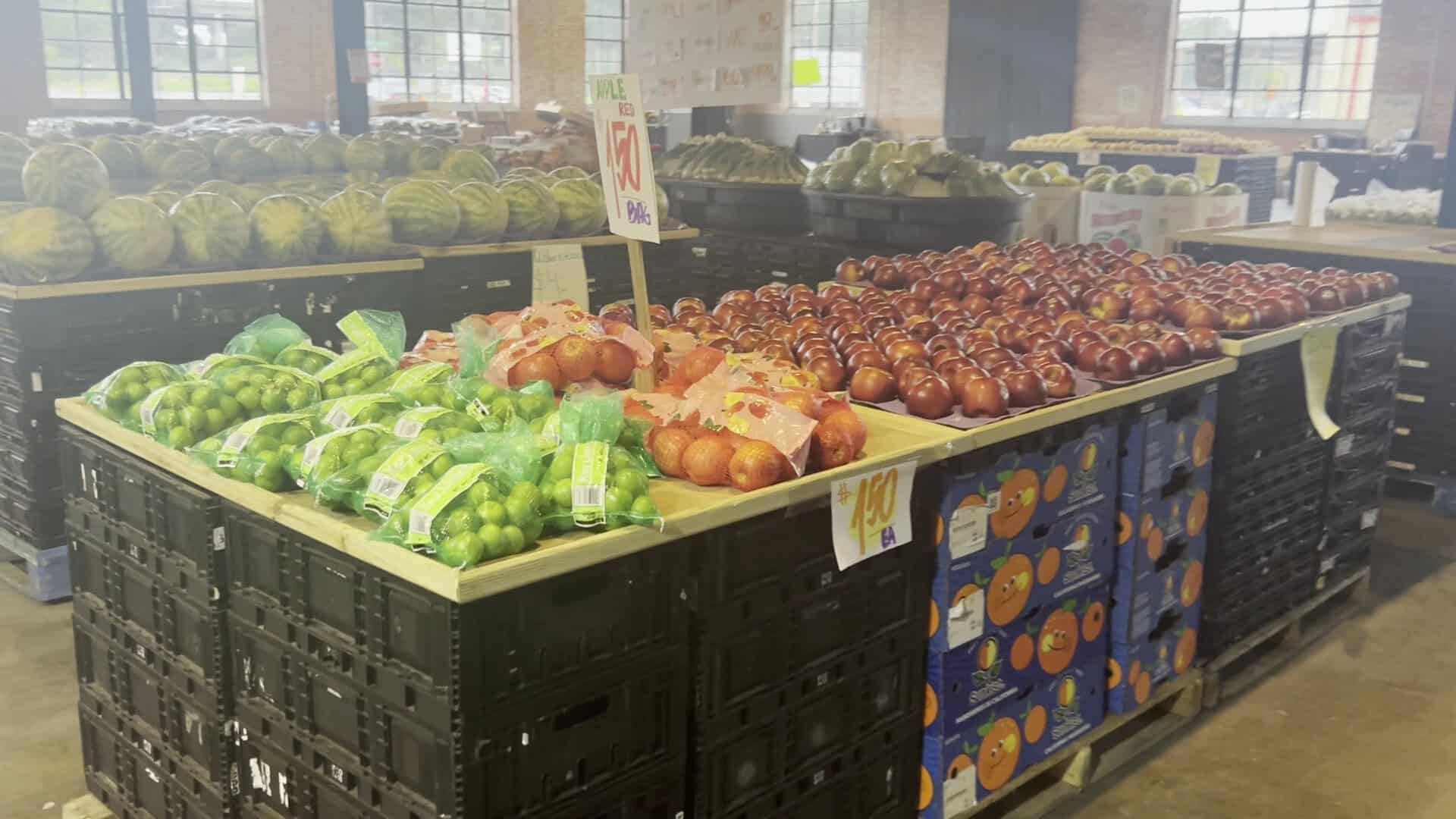 Bagged limes, oranges and apples with handwritten price signs at The Cedar Market Ranch in Dallas