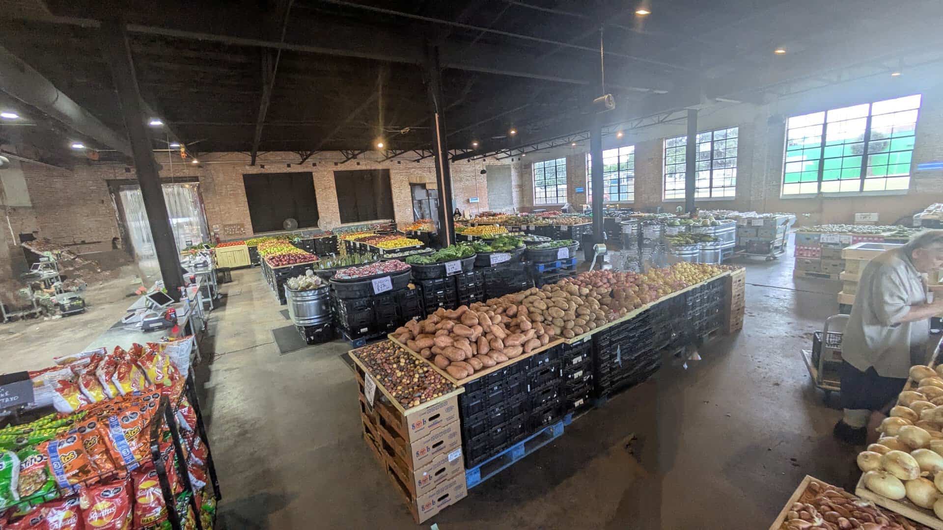 Crates of potatoes and produce on the warehouse floor at The Cedar Market Ranch in Dallas
