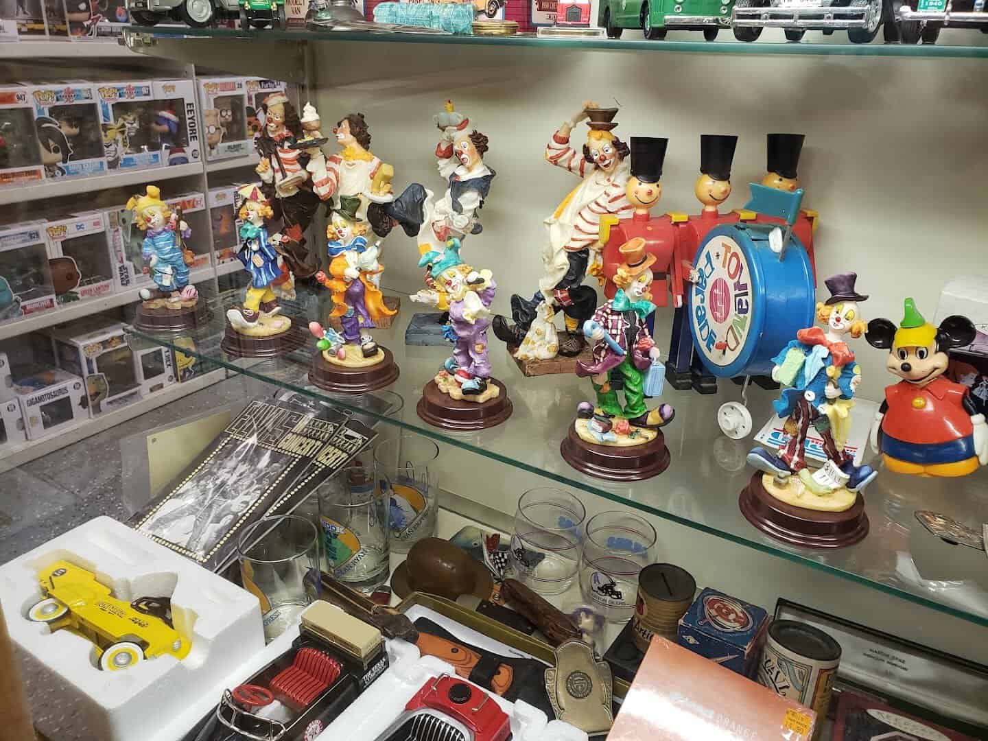 A glass case of ceramic figurines and collectibles at Cole's Antique Village in Pearland, Texas