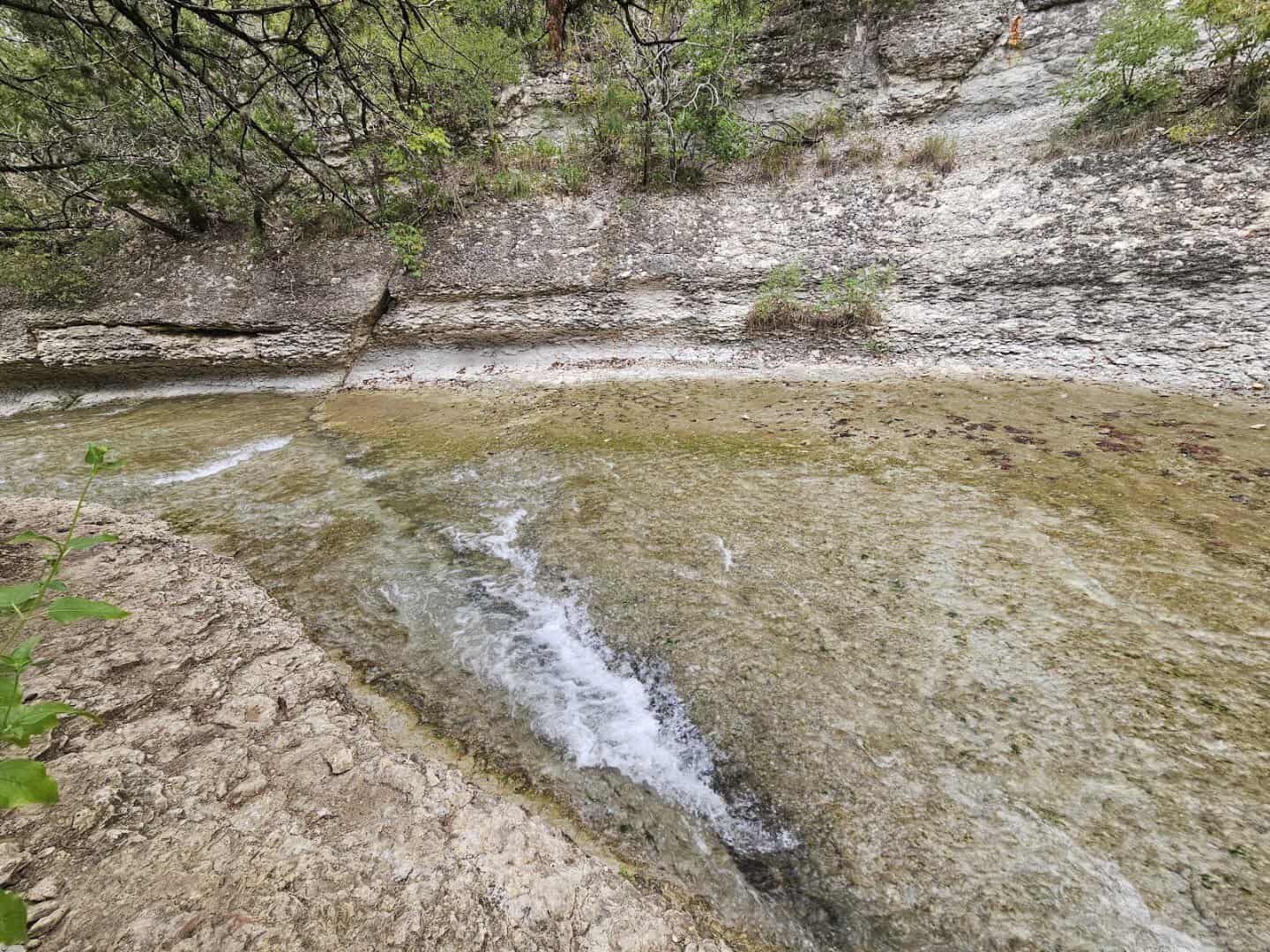 Water flowing over chalk rock shelves at Chalk Ridge Falls Park in Belton, Texas