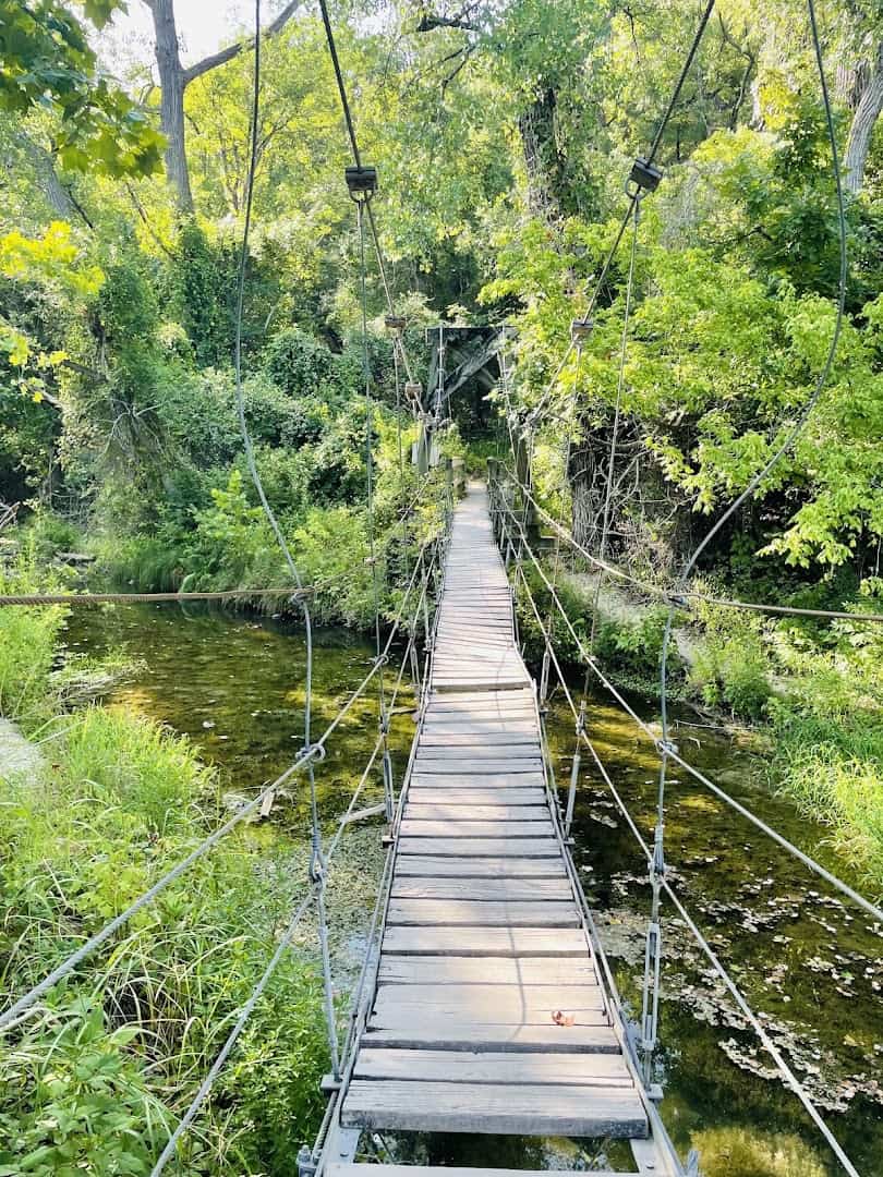Suspension bridge crossing the river at Chalk Ridge Falls Park near Belton, Texas