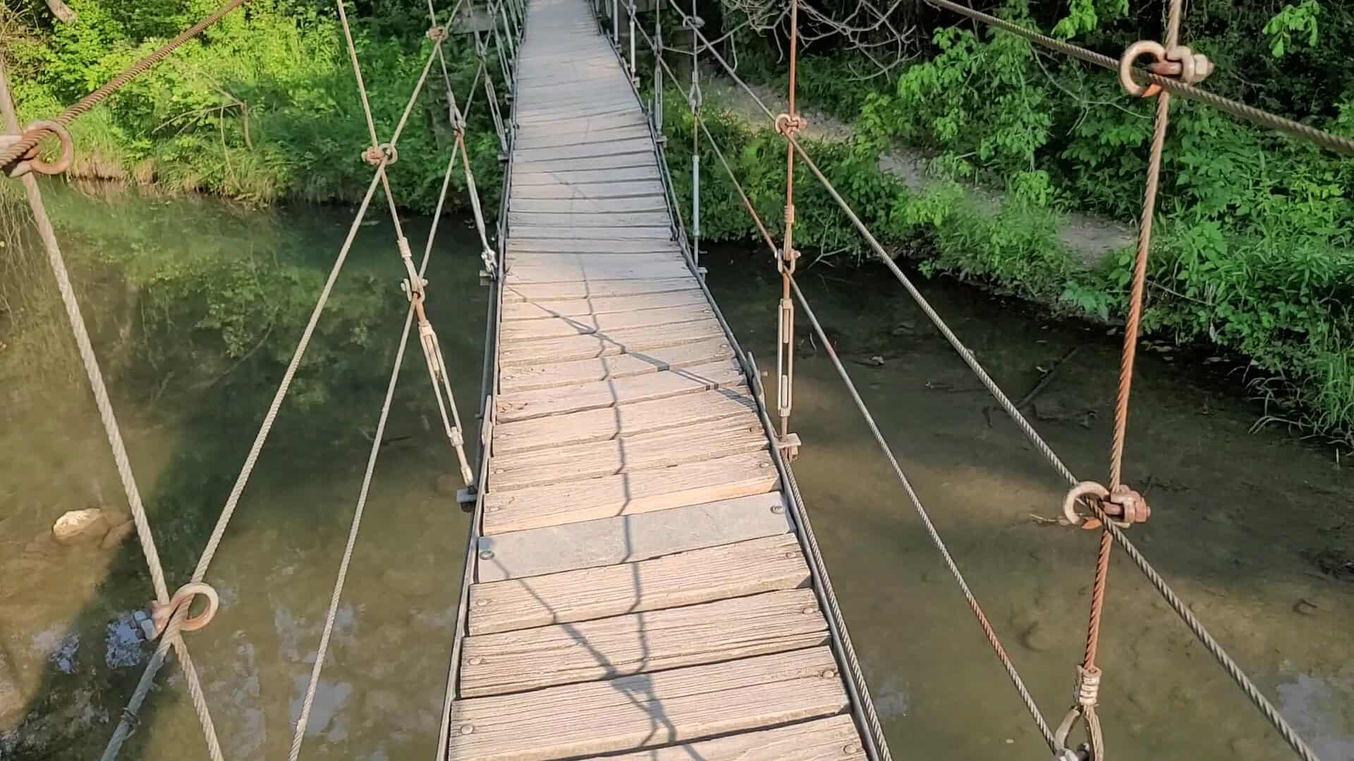 Cable suspension bridge over the Lampasas River at Chalk Ridge Falls Park in Belton, Texas