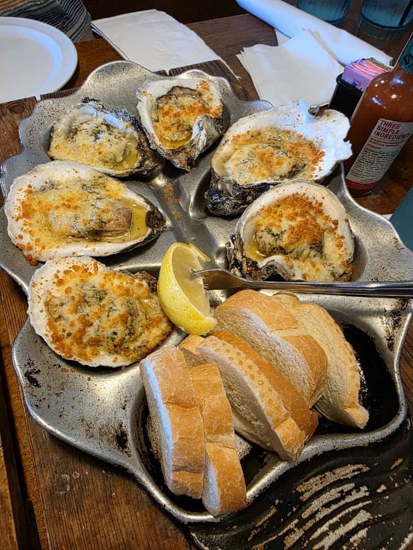 Chargrilled oysters with garlic butter and bread at Topwater Grill in San Leon
