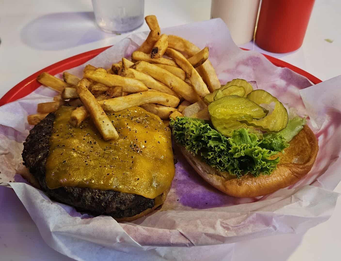 Cheddar cheeseburger with a basket of fries at Roadhouse in Bastrop, Texas