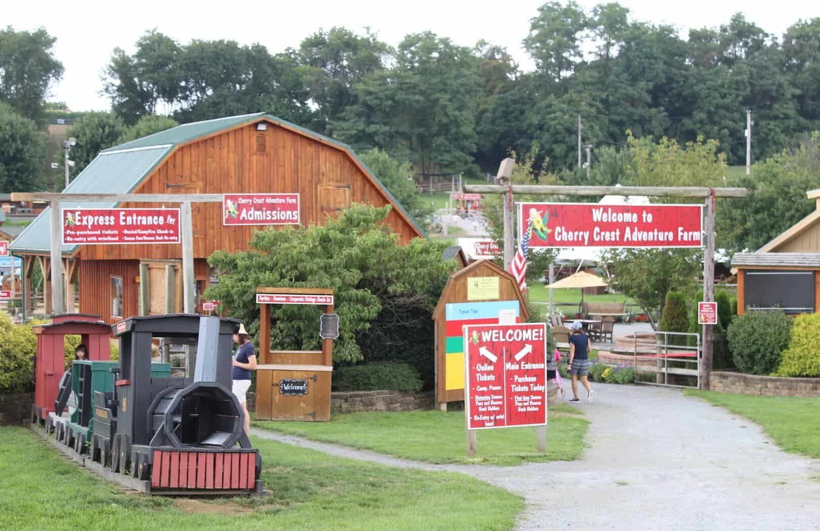 Welcome sign and entrance train station at Cherry Crest Adventure Farm in Ronks, Pennsylvania