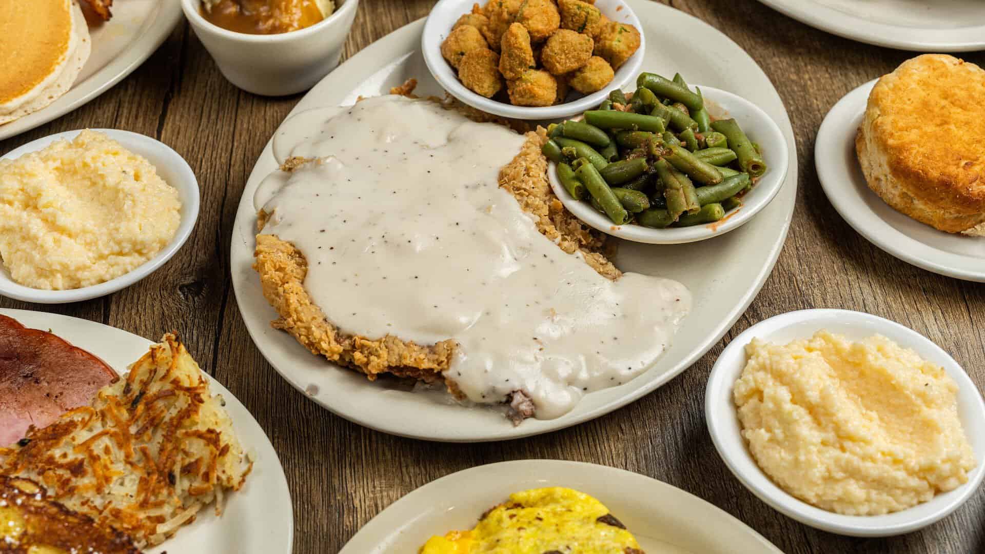 A plate of chicken fried steak with a biscuit, gravy, grits and eggs at Bobbie's Southern Kitchen