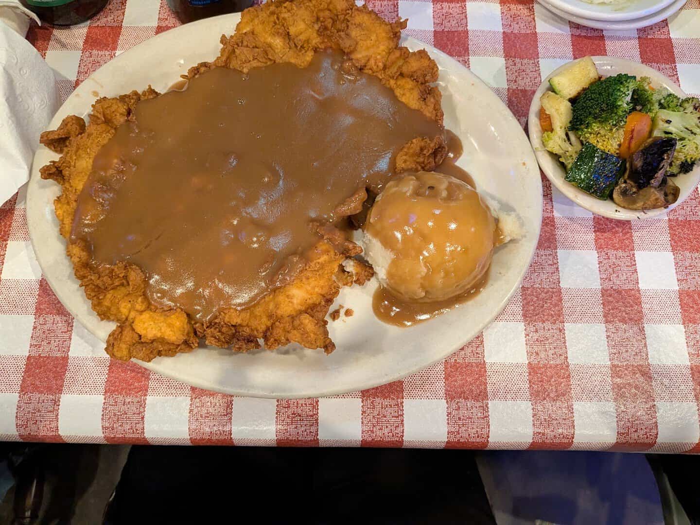 Chicken fried steak covered in brown gravy at Hofbrau Steaks in Porter, Texas