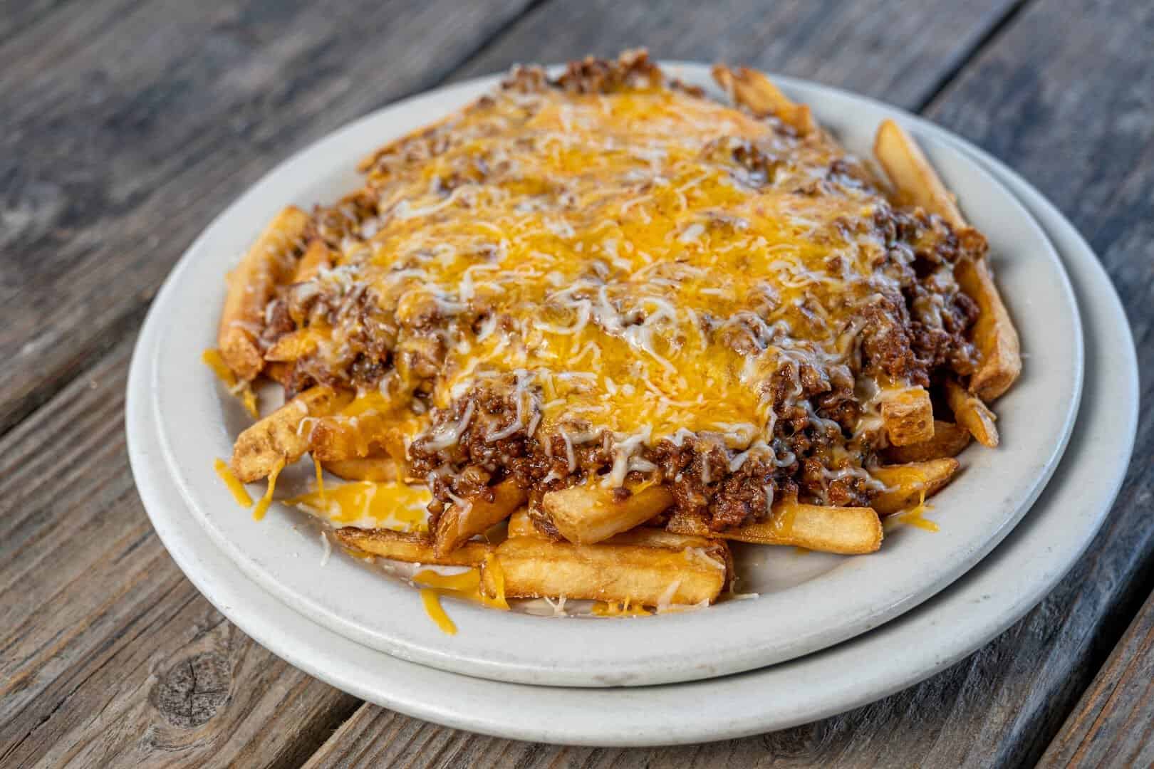Chili cheese fries topped with melted cheddar at Roadhouse in Bastrop, Texas