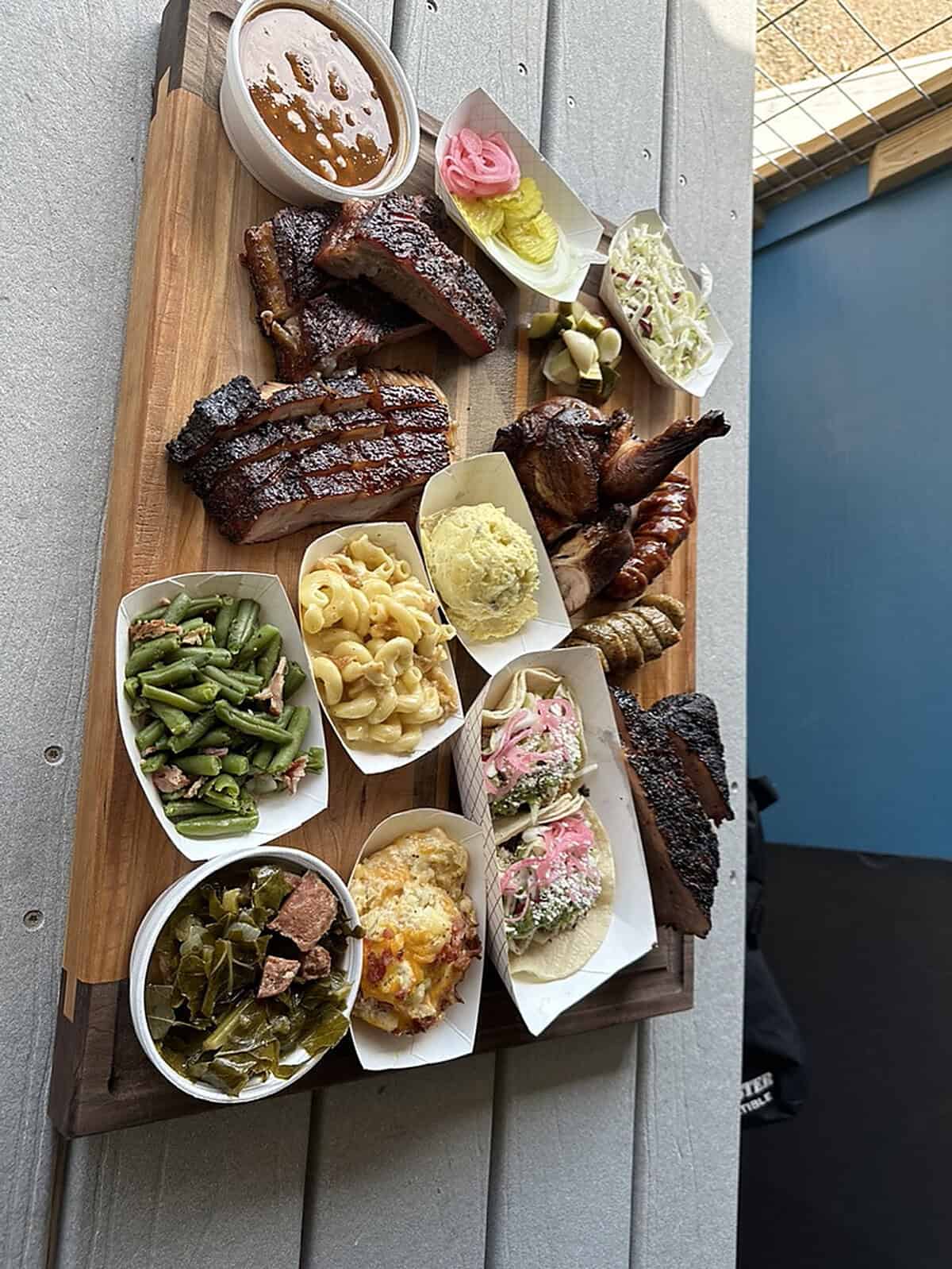 Smoked barbecue plate with ribs, brisket and sides at Coastal Que BBQ in Matagorda, Texas