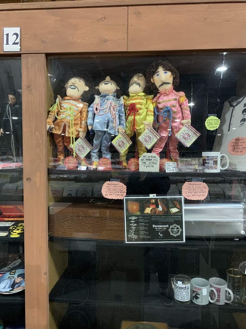 Glass display case of music collectibles at Forever Young Records in Grand Prairie, Texas