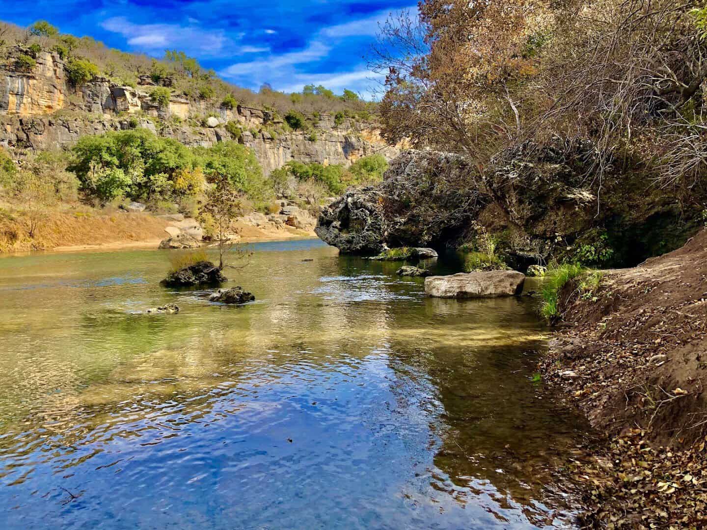Clear green water of the Colorado River over limestone at Colorado Bend State Park