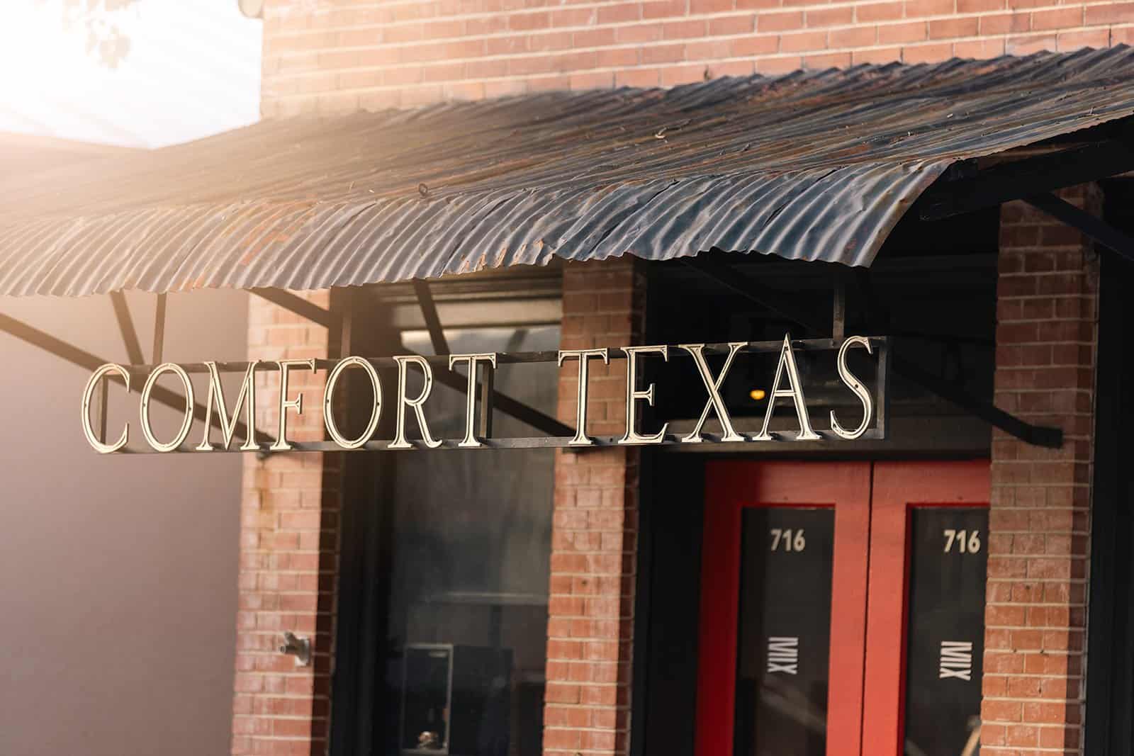 Historic brick storefront reading Comfort Texas in Comfort, Texas
