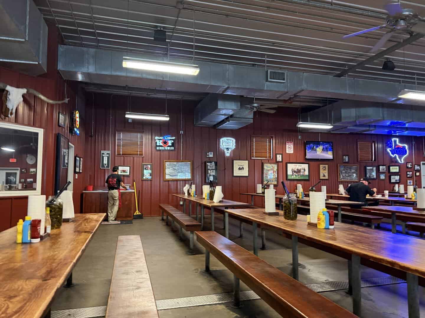 Communal wooden tables in the dining hall at Cooper's in Fort Worth