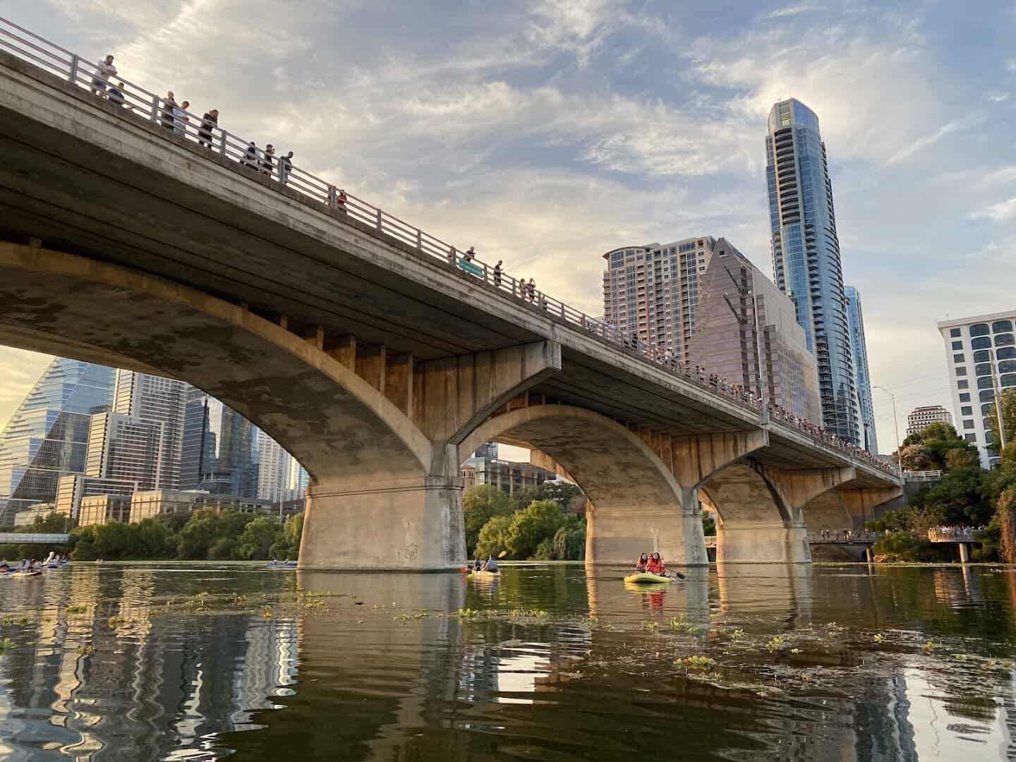 The concrete arches of the Congress Avenue Bridge seen from Lady Bird Lake in Austin