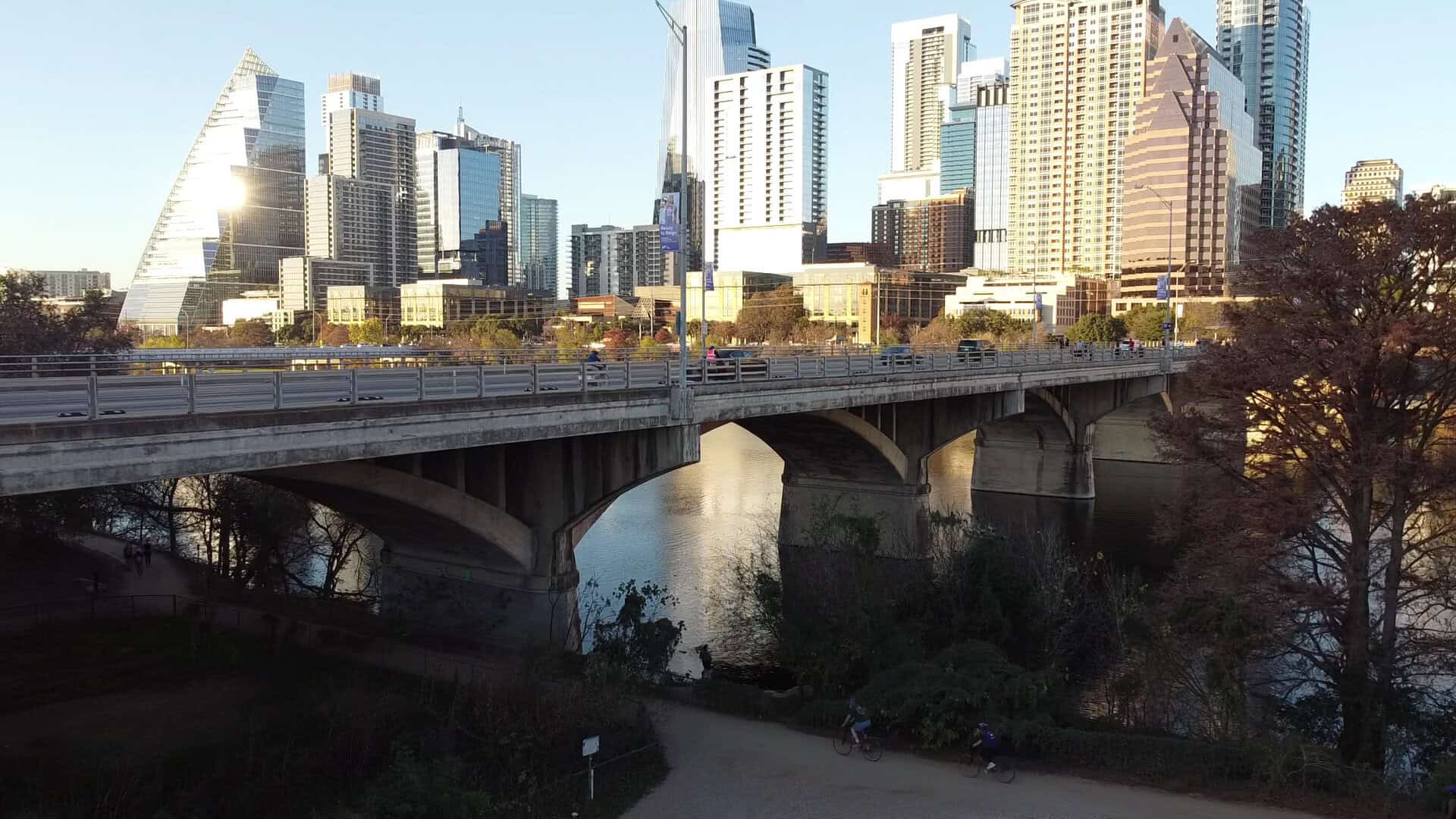 The Congress Avenue Bridge and its arches seen from the bank in Austin
