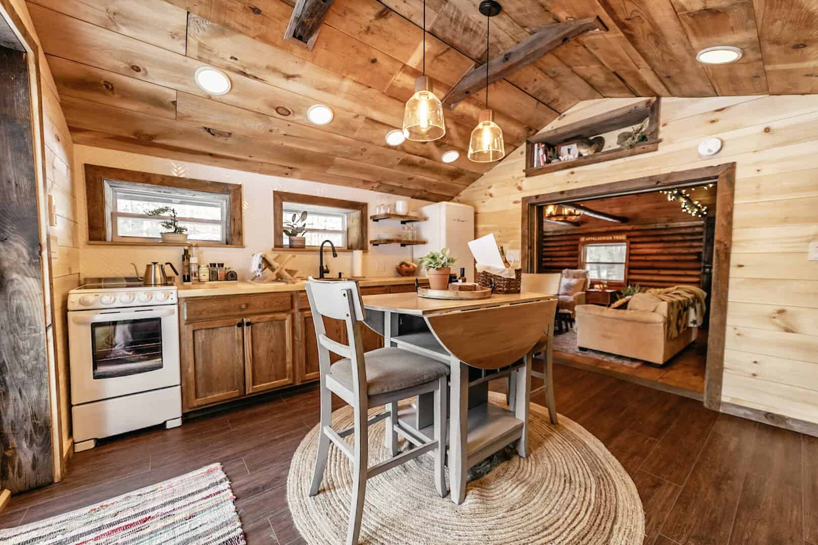 Warm, lamp-lit log cabin interior at The Conscious Cabin in Conway, New Hampshire