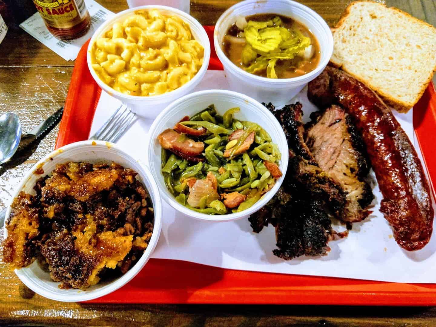 Tray of smoked brisket and sausage with beans, mac and cheese and bread at Cooper's Old Time Pit Bar-B-Que in Austin