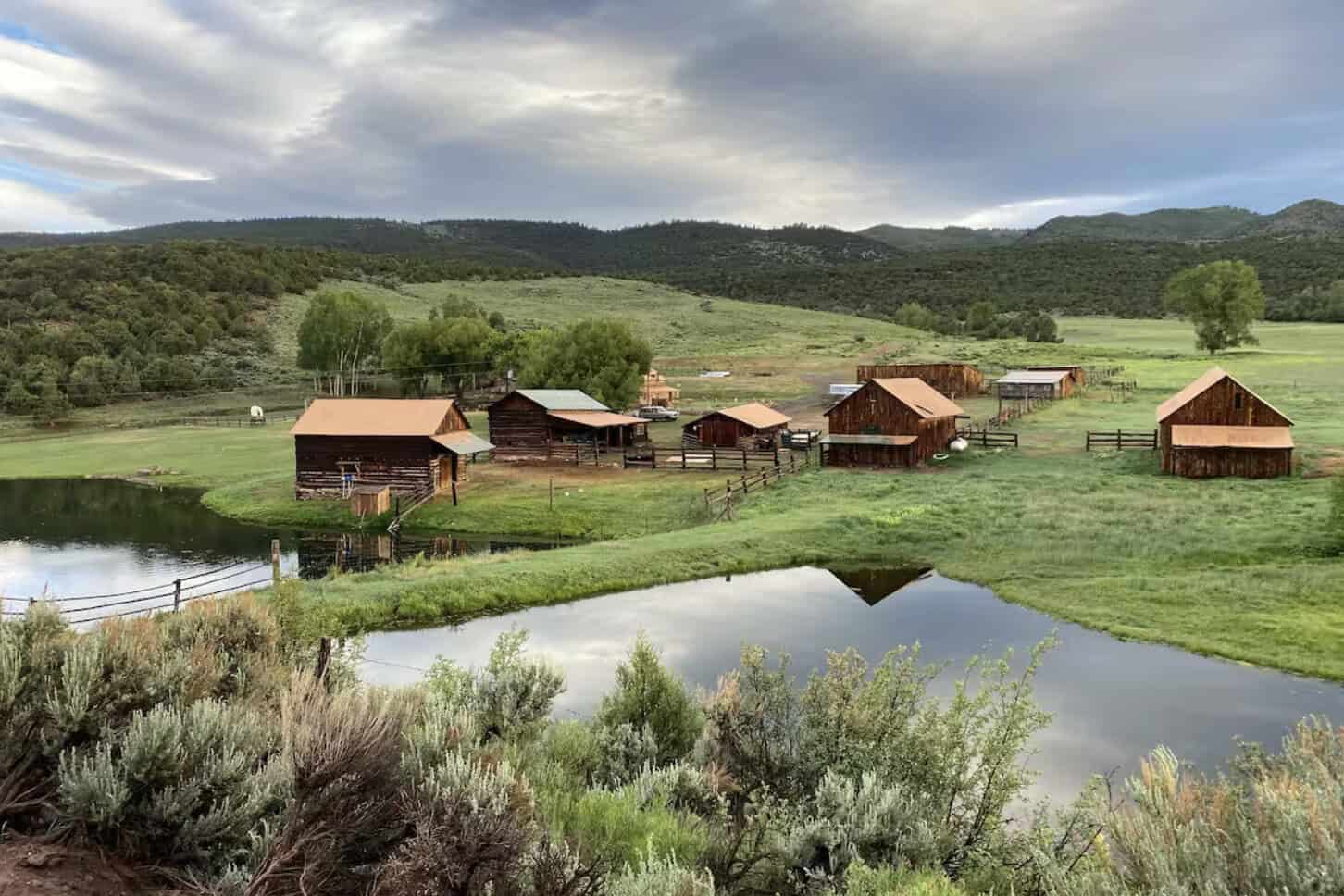 Off-grid cabins beside a pond in the mountains at Copper Spur Ranch near McCoy, Colorado